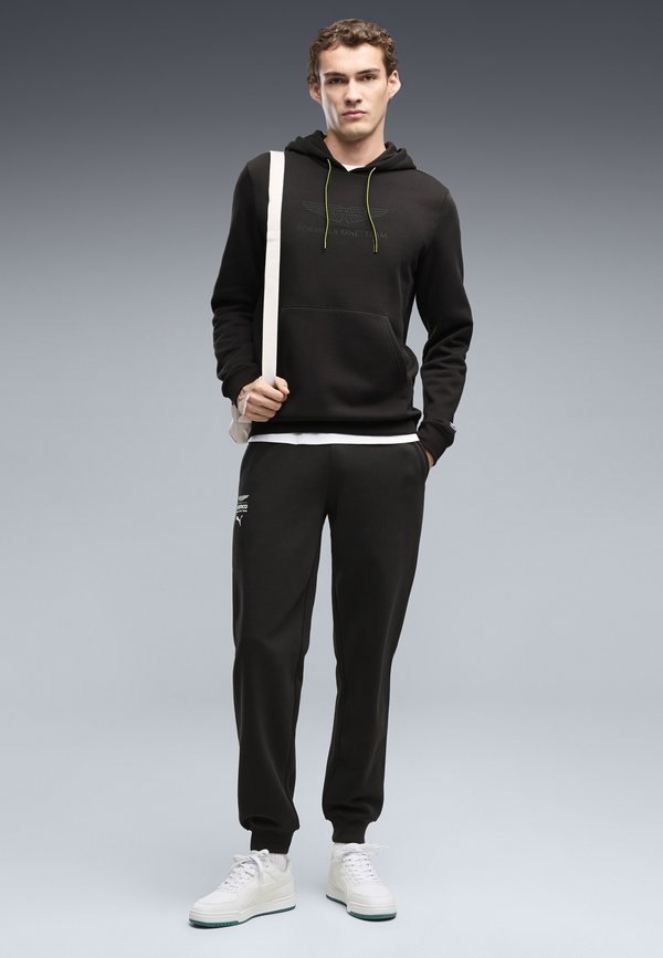 Puma PUMA X ASTON MARTIN ARAMCO F1® TEAM ESSENTIALS JOGGINGHOSE - Tracksuit bottoms - black