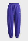 adidas Sportswear ESSENTIALS LINEAR CUFFED PANTS - Tracksuit bottoms - pure purple/white
