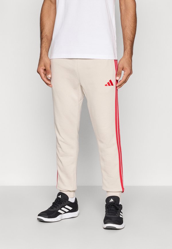 adidas Sportswear ESSENTIALS THREE STRIPES FRENCH TERRY - Tracksuit bottoms - alumina/pure ruby