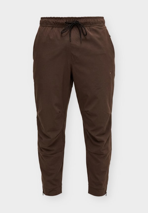 Nike Performance UNLIMITED - Tracksuit bottoms - baroque brown/black