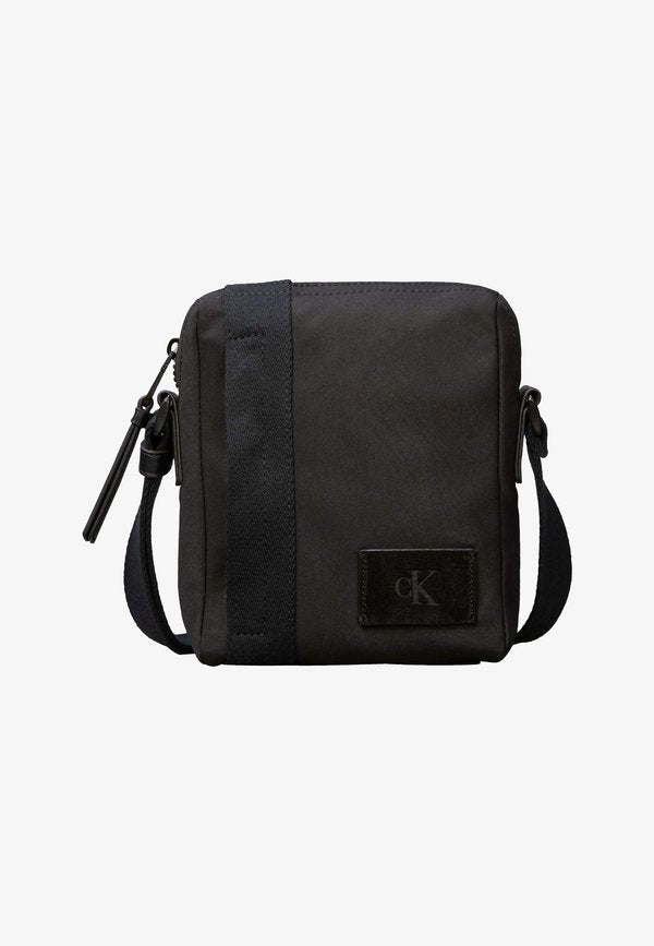 Calvin Klein REPORTER - Cross body bag - black