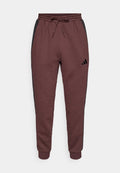 adidas Sportswear REGULAR FIT - Tracksuit bottoms - shadow brown/black