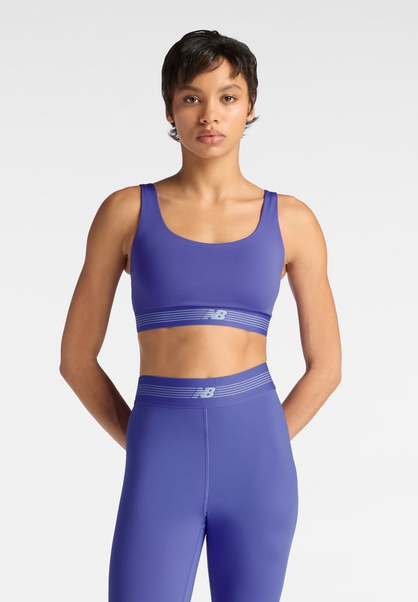 New Balance AC TRAIN BRA - Medium support sports bra - electric purple