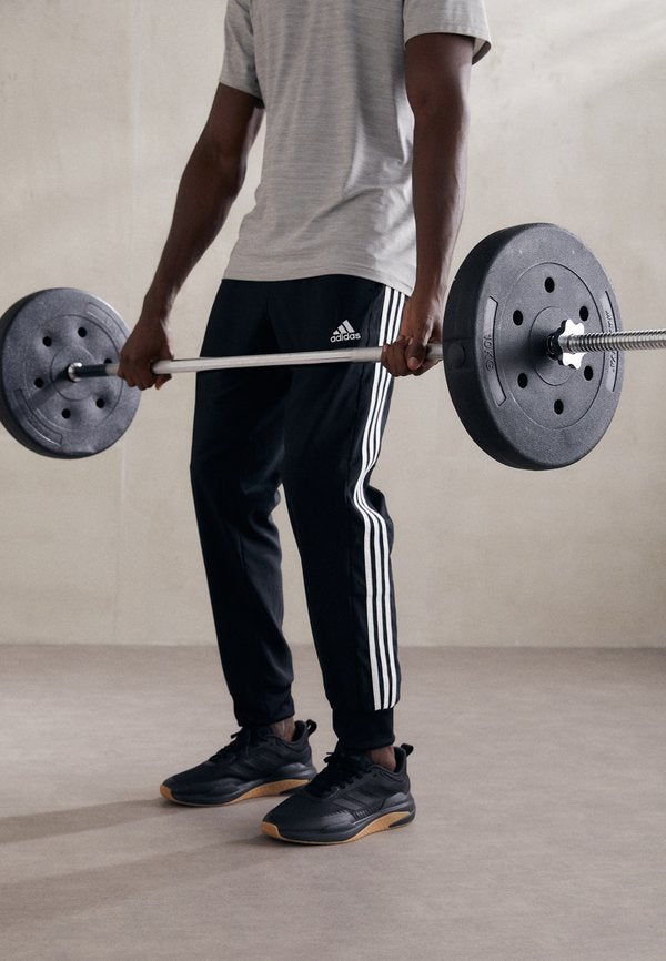 adidas Sportswear ESSENTIALS 3-STRIPES - Tracksuit bottoms - black/white