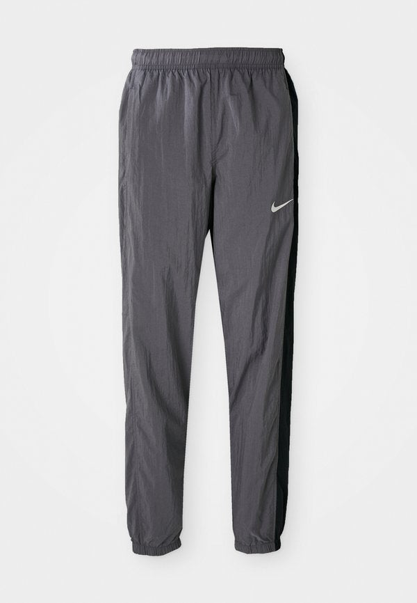 Nike Performance STANDARD FIT - Tracksuit bottoms - light graphite