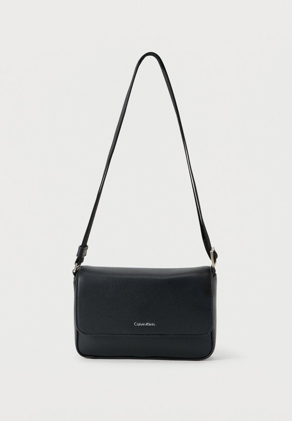 Calvin Klein RAISED SMALL FLAP MESSENGER - Cross body bag - black