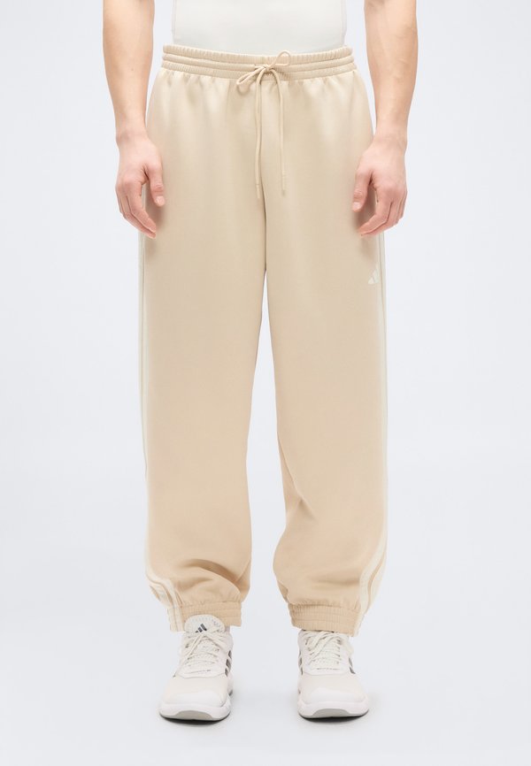 adidas Sportswear STADIUM TRACK - Tracksuit bottoms - beige/white