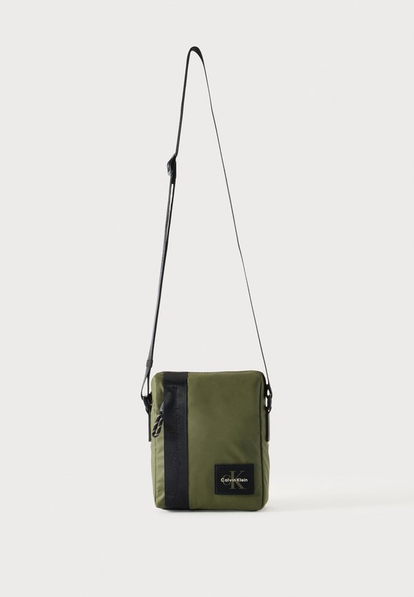 Calvin Klein RUBBERIZED REPORTER - Cross body bag - olive