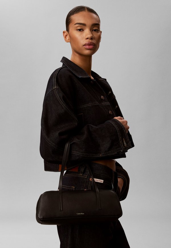 Calvin Klein FOIL LOGO BAULETTO - Handbag - black