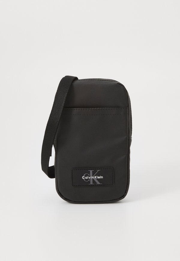 Calvin Klein TECH UTILITY RUBBER - Cross body bag - black