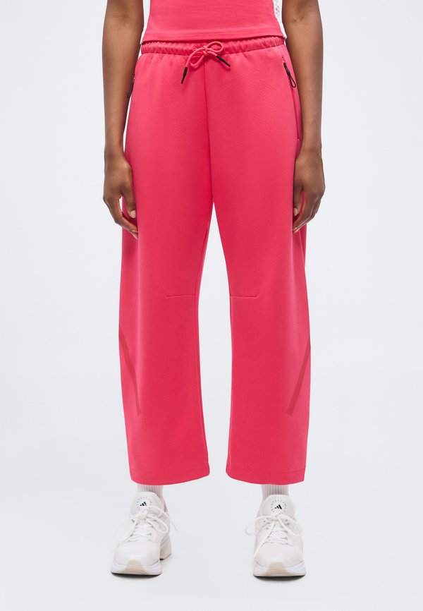 adidas Sportswear Z.N.E. OPEN HEM - Tracksuit bottoms - power pink