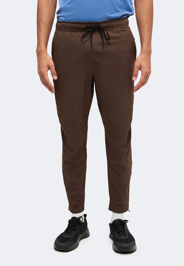 Nike Performance UNLIMITED - Tracksuit bottoms - baroque brown/black